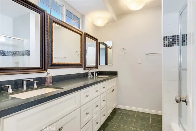 a bathroom with a double vanity sink and a mirror