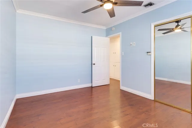 an empty room with fan and entrance