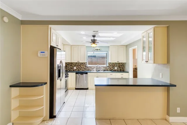 a kitchen with stainless steel appliances granite countertop a refrigerator and a stove