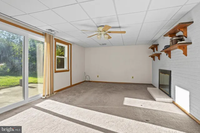a view of a livingroom with a ceiling fan and window