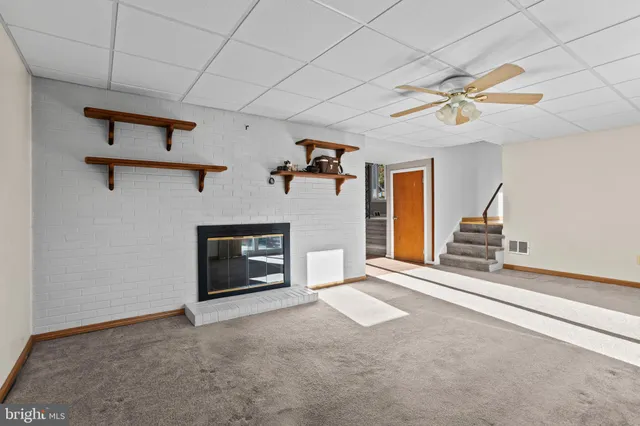 a view of an empty room with a fireplace