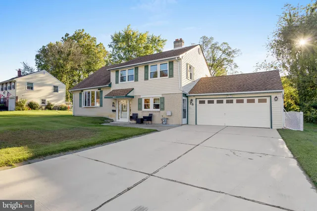 a view of house with yard and green space