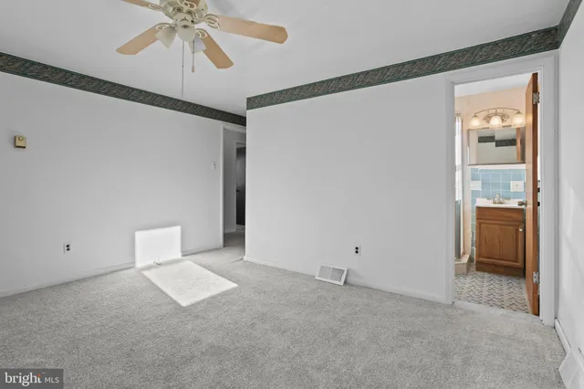 a view of an empty room with a fan