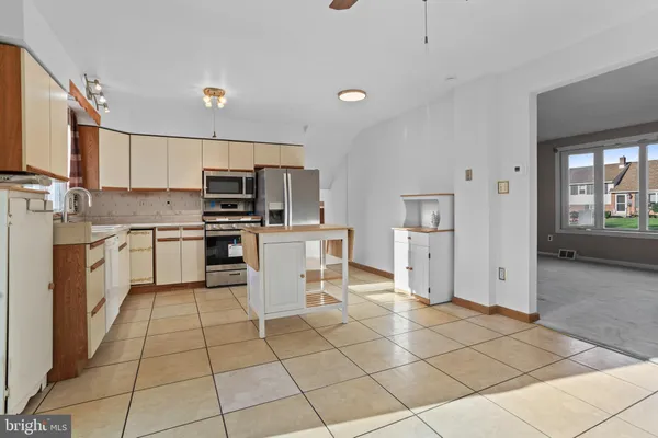 a kitchen with a stove a sink and a refrigerator