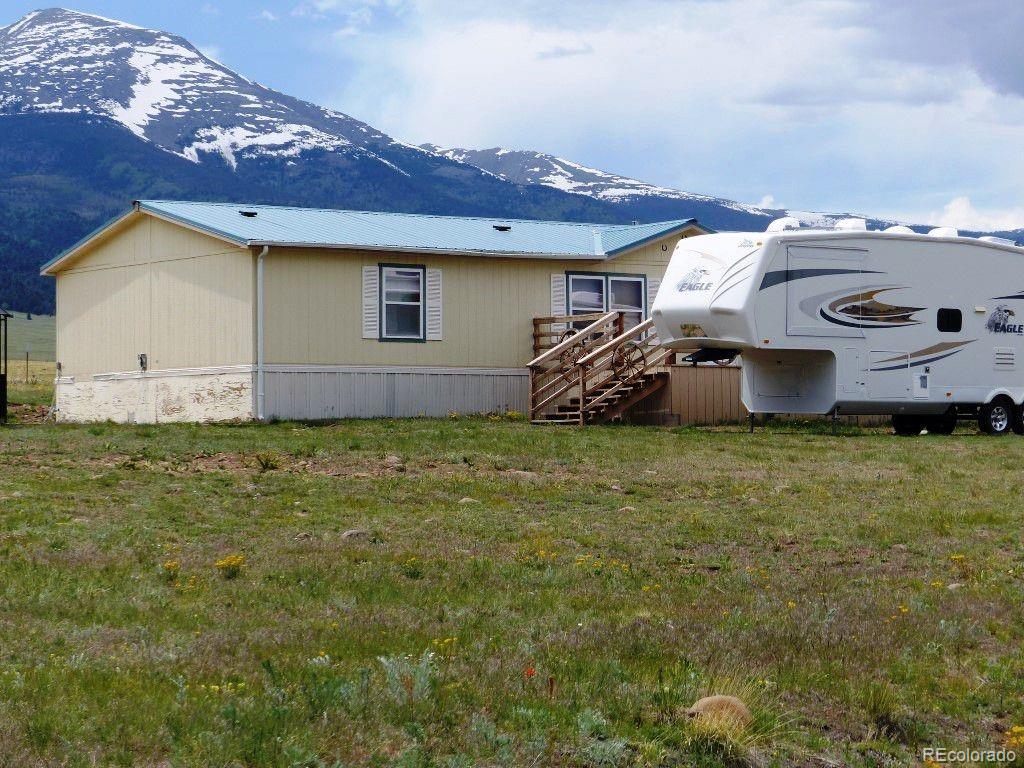 985 Prairie Road Westcliffe, CO 81252 - Photo 12 of 35 a view of a house with a yard and garage