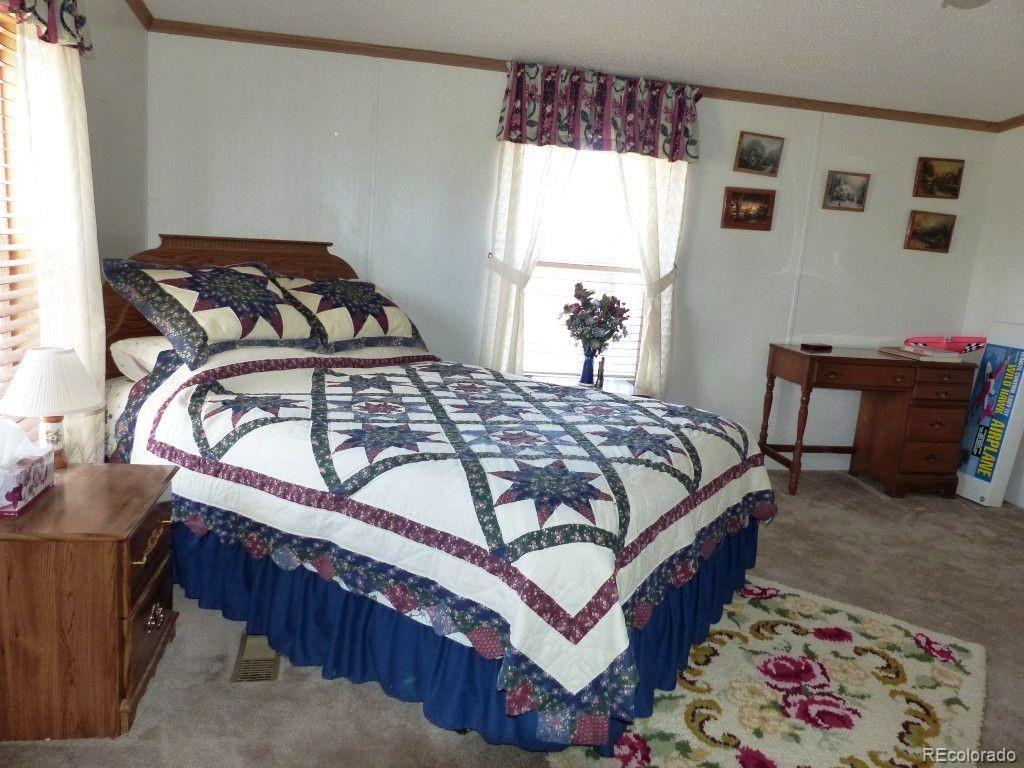 985 Prairie Road Westcliffe, CO 81252 - Photo 17 of 35 a bedroom with a bed and a window