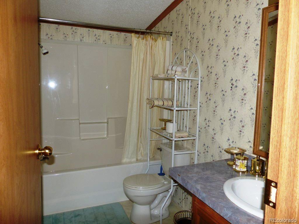 985 Prairie Road Westcliffe, CO 81252 - Photo 18 of 35 a bathroom with a sink toilet and shower