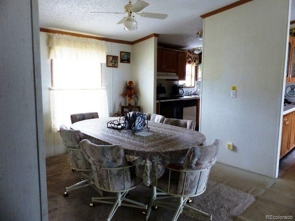 985 Prairie Road Westcliffe, CO 81252 - Photo 20 of 35 a view of a dining room with furniture and a chandelier