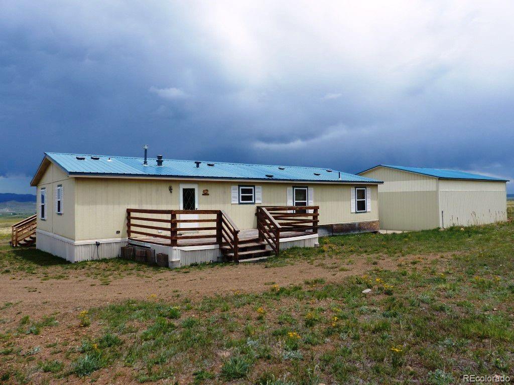 985 Prairie Road Westcliffe, CO 81252 - Photo 25 of 35 a view of a house with backyard and chairs