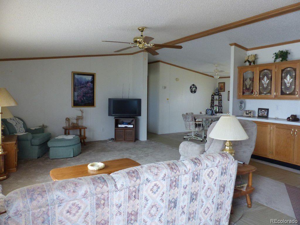 985 Prairie Road Westcliffe, CO 81252 - Photo 30 of 35 a bedroom with furniture and a mirror