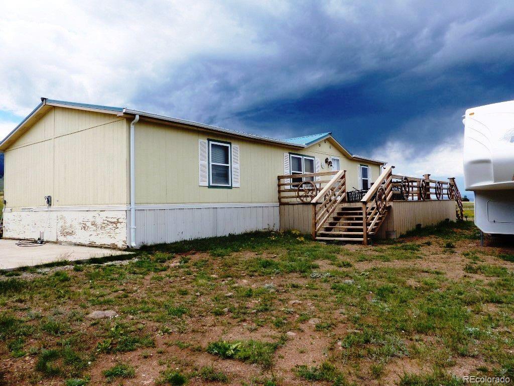 985 Prairie Road Westcliffe, CO 81252 - Photo 3 of 35 a backyard of a house with table and chairs