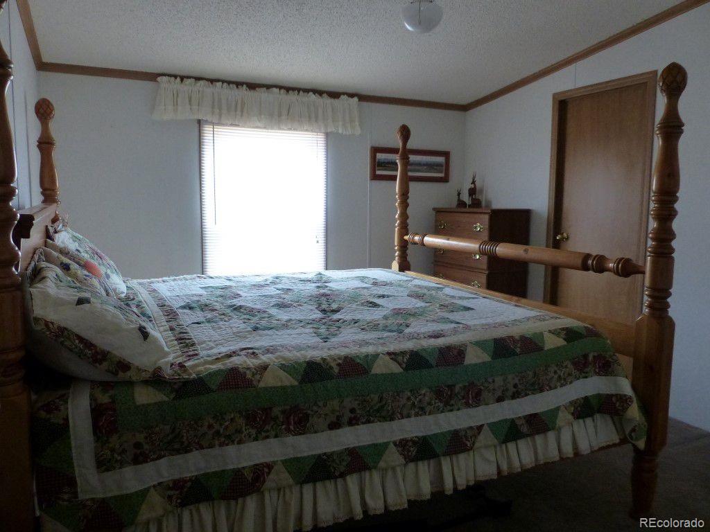 985 Prairie Road Westcliffe, CO 81252 - Photo 7 of 35 a bedroom with a bed and large closet