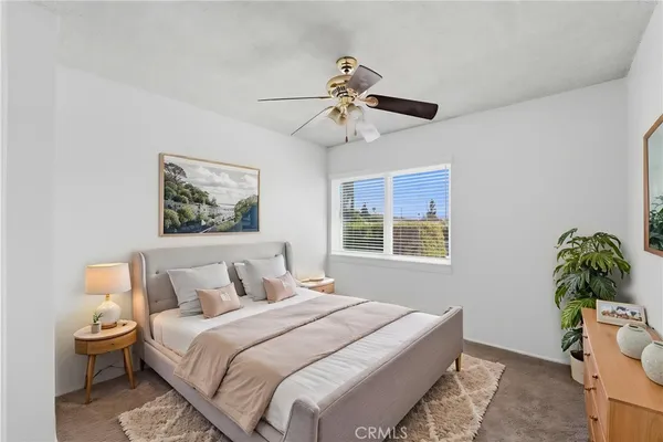 a bedroom with a bed and ceiling fan