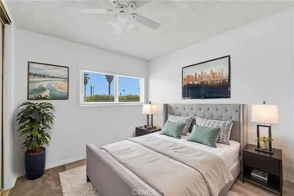 a bedroom with a bed and a painting on the wall
