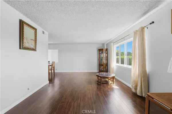 a view of a room with wooden floor and a window