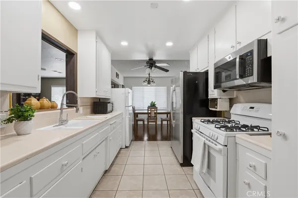 a kitchen with stainless steel appliances kitchen island granite countertop a sink and cabinets