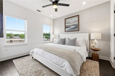 a spacious bedroom with a bed and a window