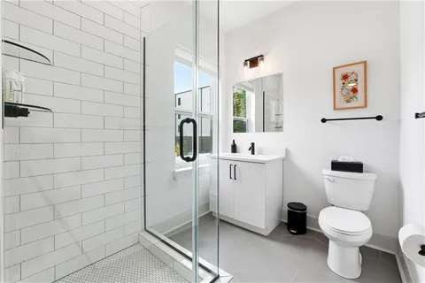 a bathroom with a toilet sink and shower