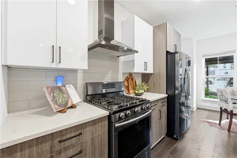 a kitchen with stainless steel appliances granite countertop a stove and a refrigerator