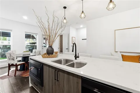 a kitchen with a sink a stove and chairs