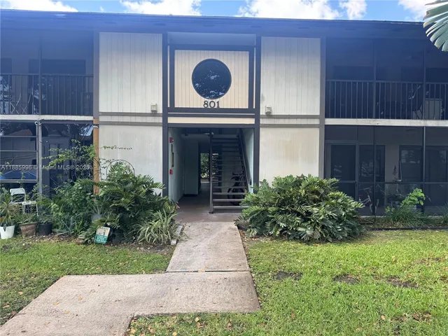 a view of house with backyard and garden
