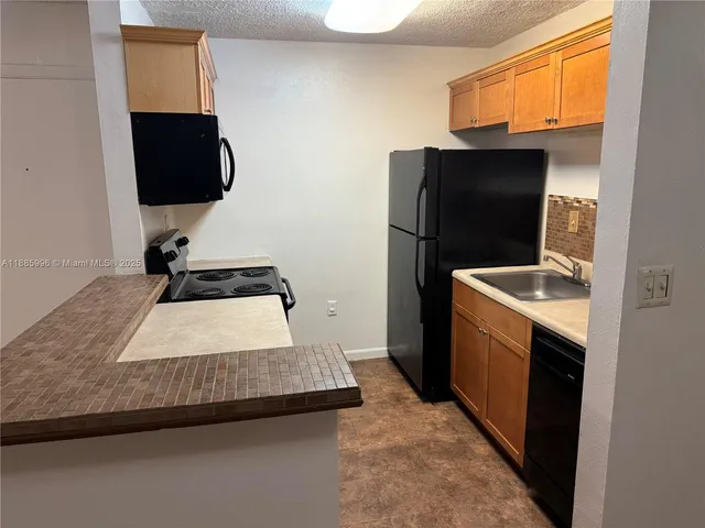 an empty room with fan and entrance