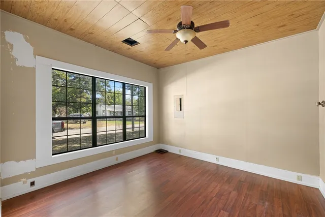 a view of room with window ceiling fan and hardwood floor