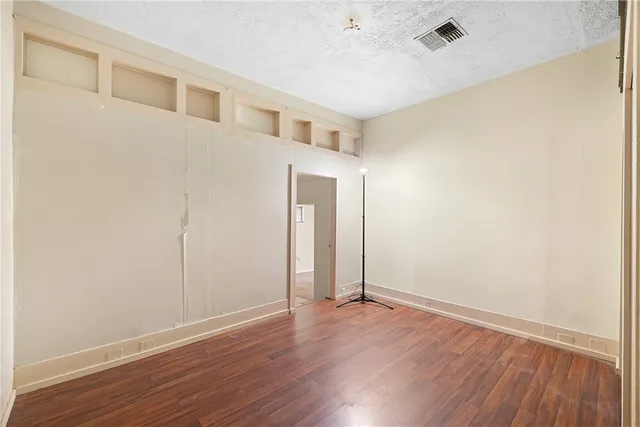 an empty room with wooden floor