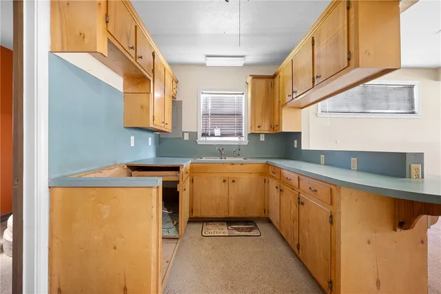 a kitchen with sink and cabinets