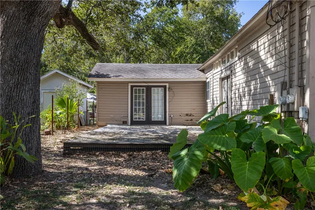 a view of house with backyard and sitting area