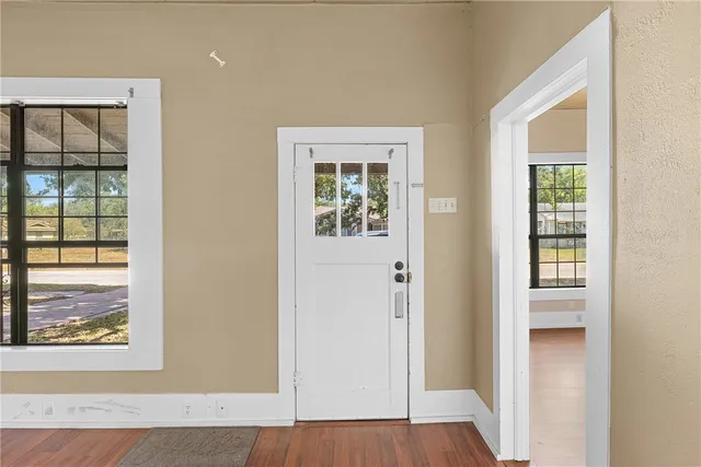 a view of an entryway with wooden floor