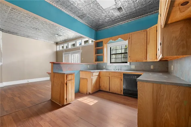 a kitchen with granite countertop a sink and a stove