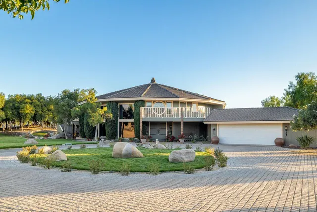 a view of a house with swimming pool and sitting area