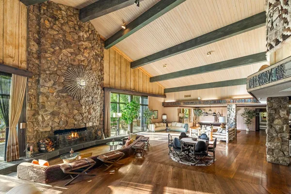 a view of a living room with furniture and floor to ceiling windows
