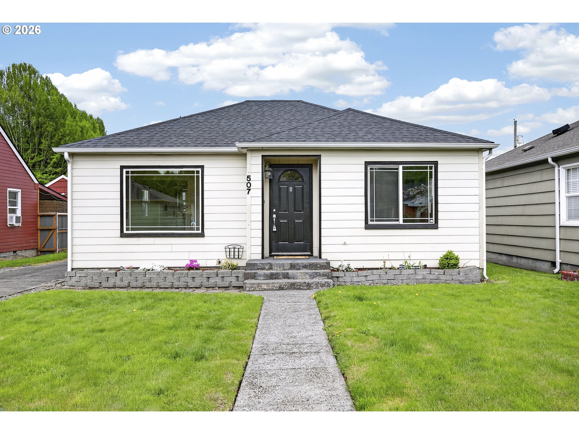 507 19th Avenue Longview, WA 98632 - Photo 2 of 17 a front view of a house with a garden and yard