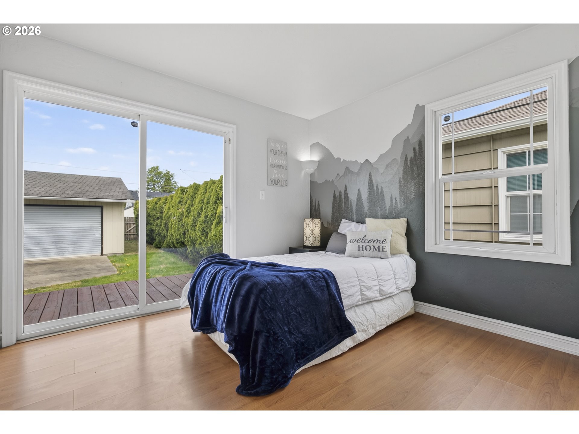 507 19th Avenue Longview, WA 98632 - Photo 8 of 17 a bedroom with a bed and a large window