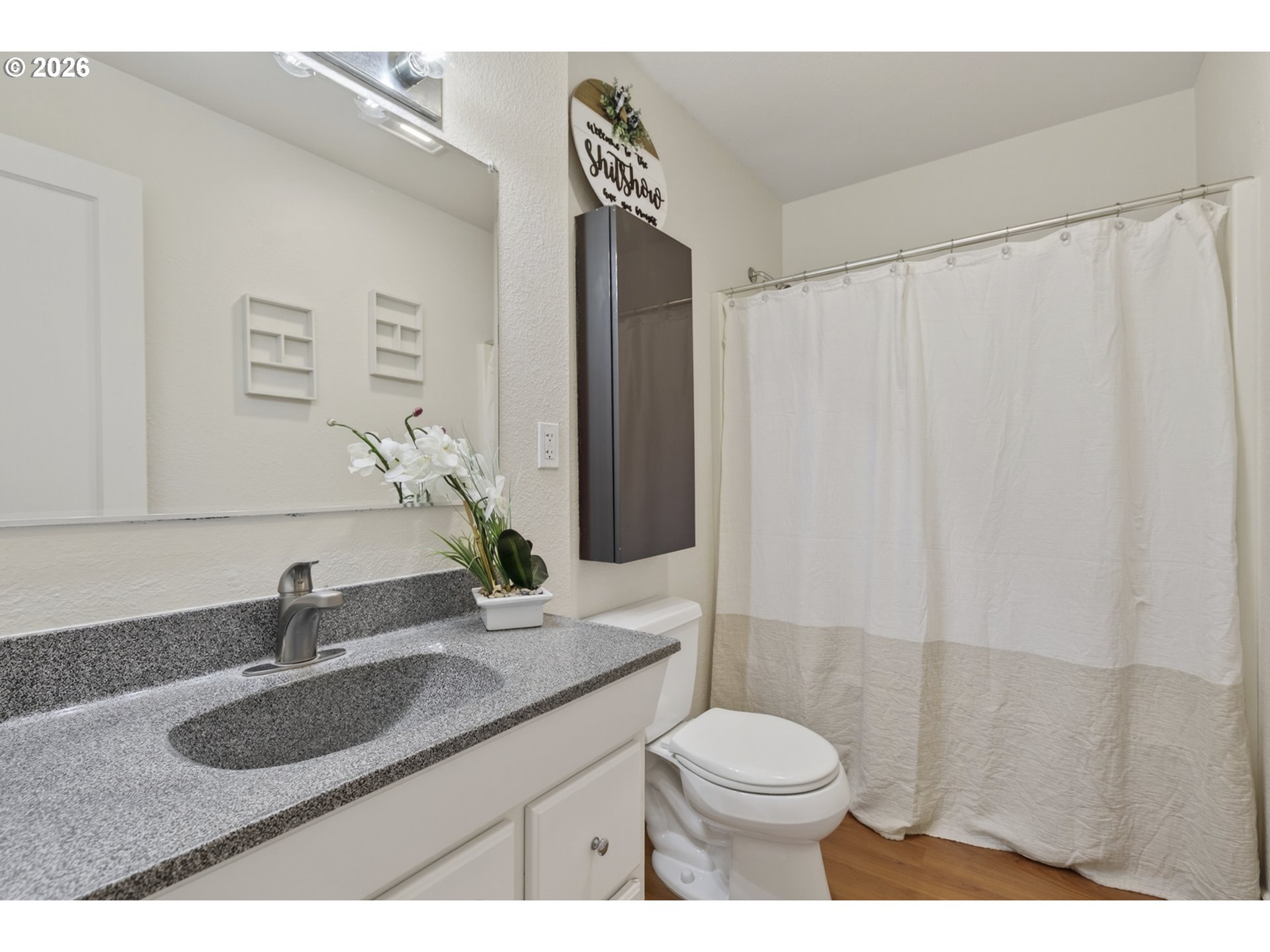 507 19th Avenue Longview, WA 98632 - Photo 10 of 17 a bathroom with a granite countertop sink toilet and shower