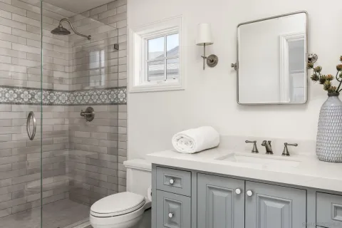 a bathroom with a granite countertop sink a toilet and shower