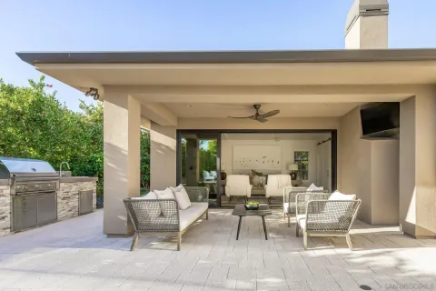 a view of a patio with dining table and chairs with wooden floor