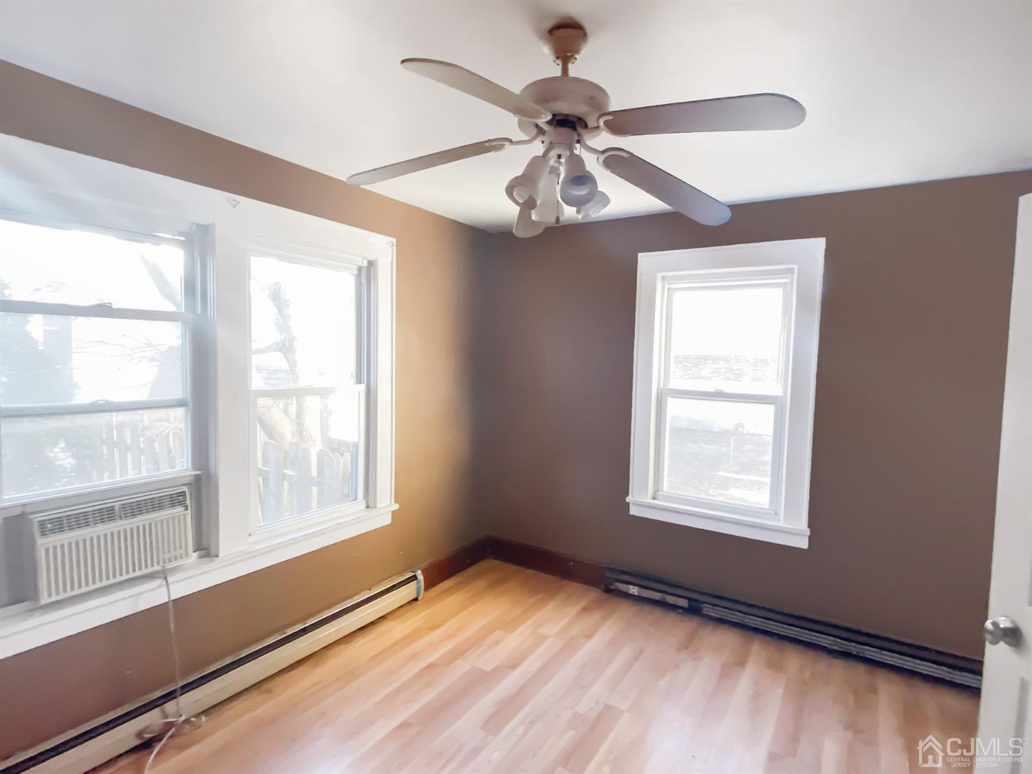 3181 Washington Road Sayreville, NJ 08859 - Photo 11 of 18 a view of an empty room with a window and wooden floor