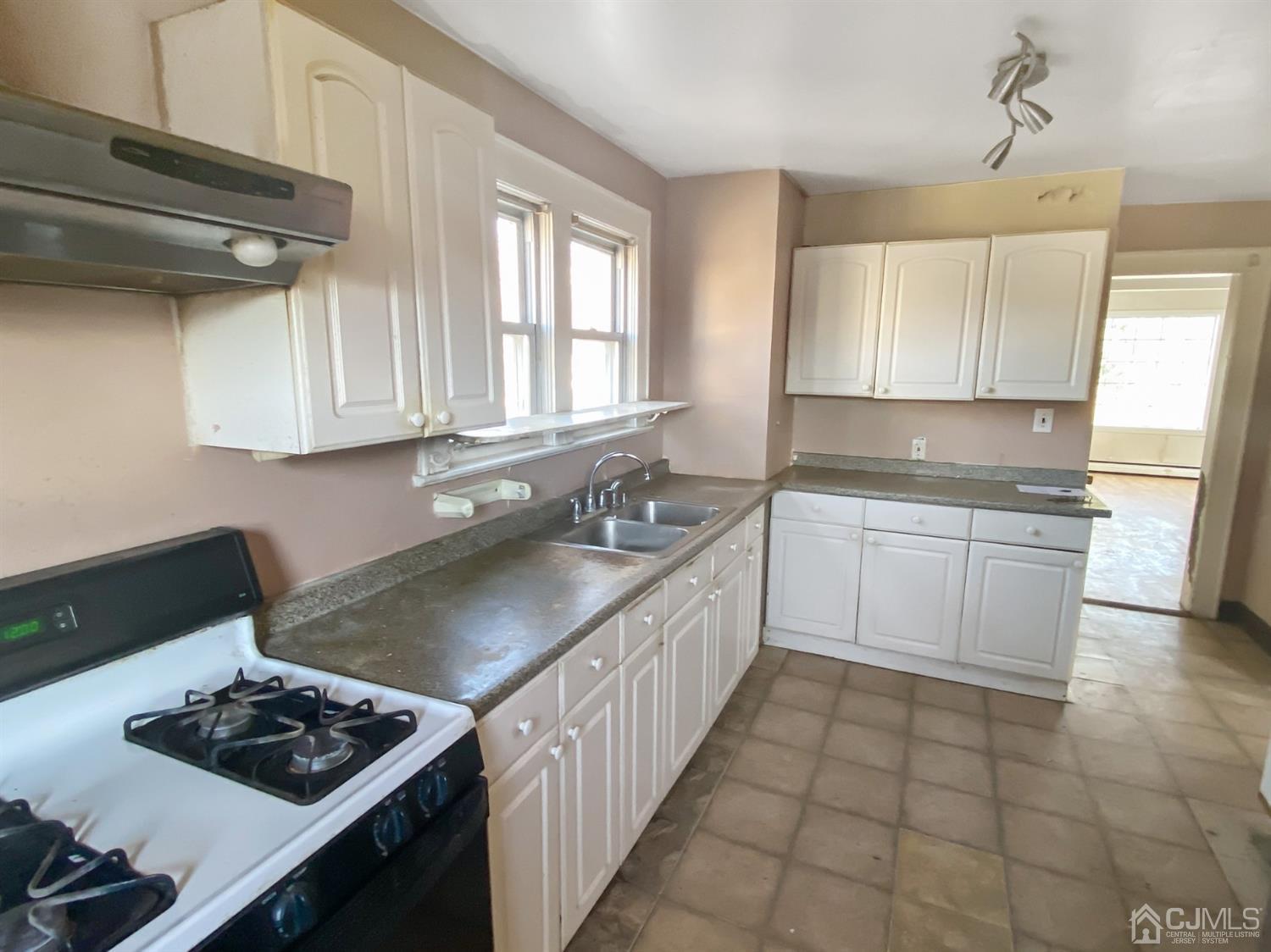 3181 Washington Road Sayreville, NJ 08859 - Photo 12 of 18 a kitchen with a sink stove and cabinets