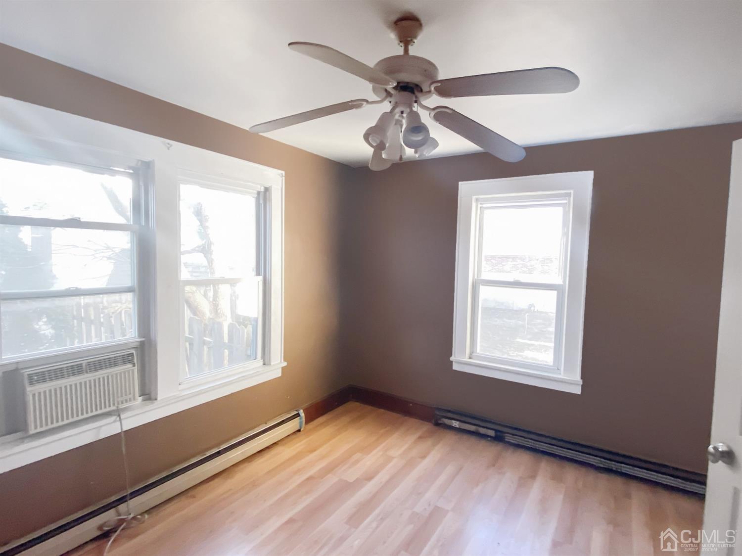 3181 Washington Road Sayreville, NJ 08859 - Photo 13 of 18 a view of an empty room with a window and wooden floor
