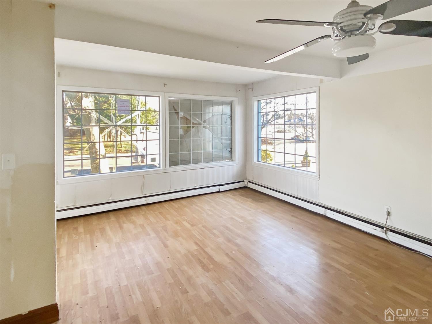 3181 Washington Road Sayreville, NJ 08859 - Photo 14 of 18 an empty room with wooden floor and windows