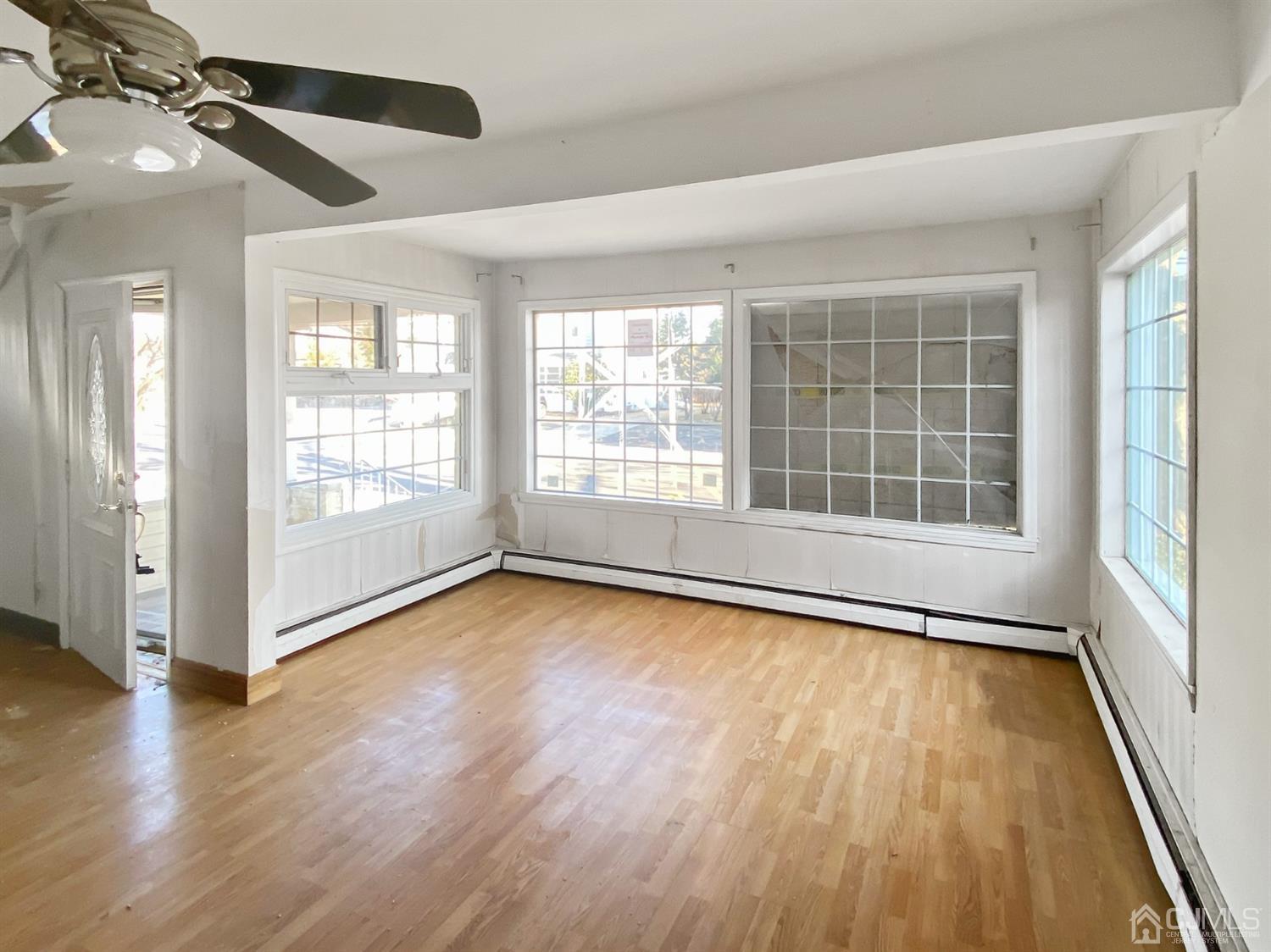 3181 Washington Road Sayreville, NJ 08859 - Photo 15 of 18 an empty room with wooden floor and windows