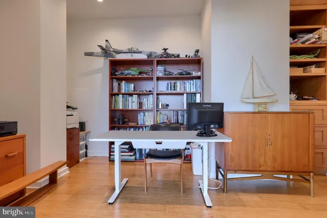 a dining room with stainless steel appliances furniture a rug and a kitchen view
