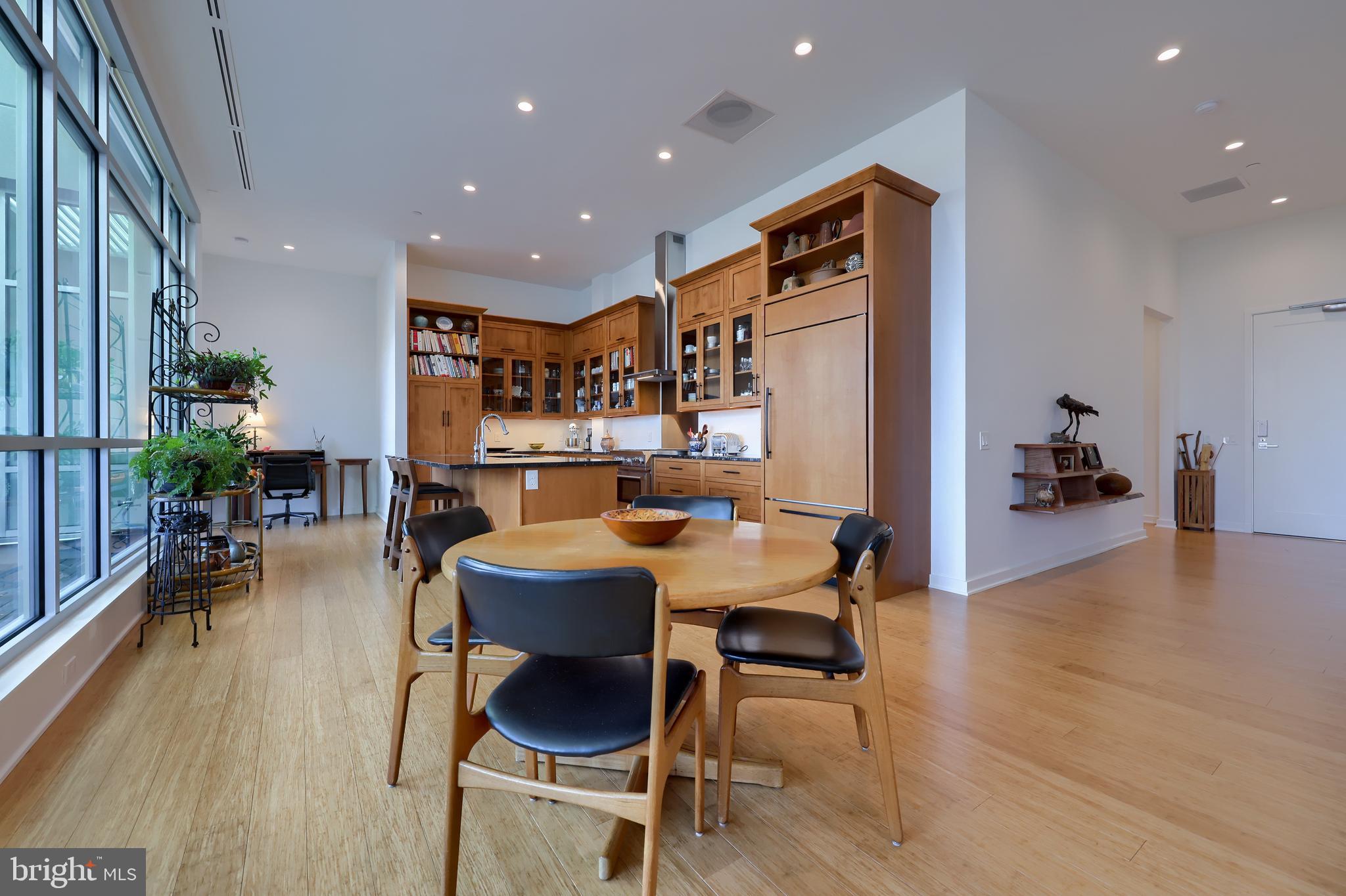 101 North Queen Street, Unit 404 Lancaster, PA 17603 - Photo 12 of 30 a dining room with stainless steel appliances furniture a rug and a kitchen view