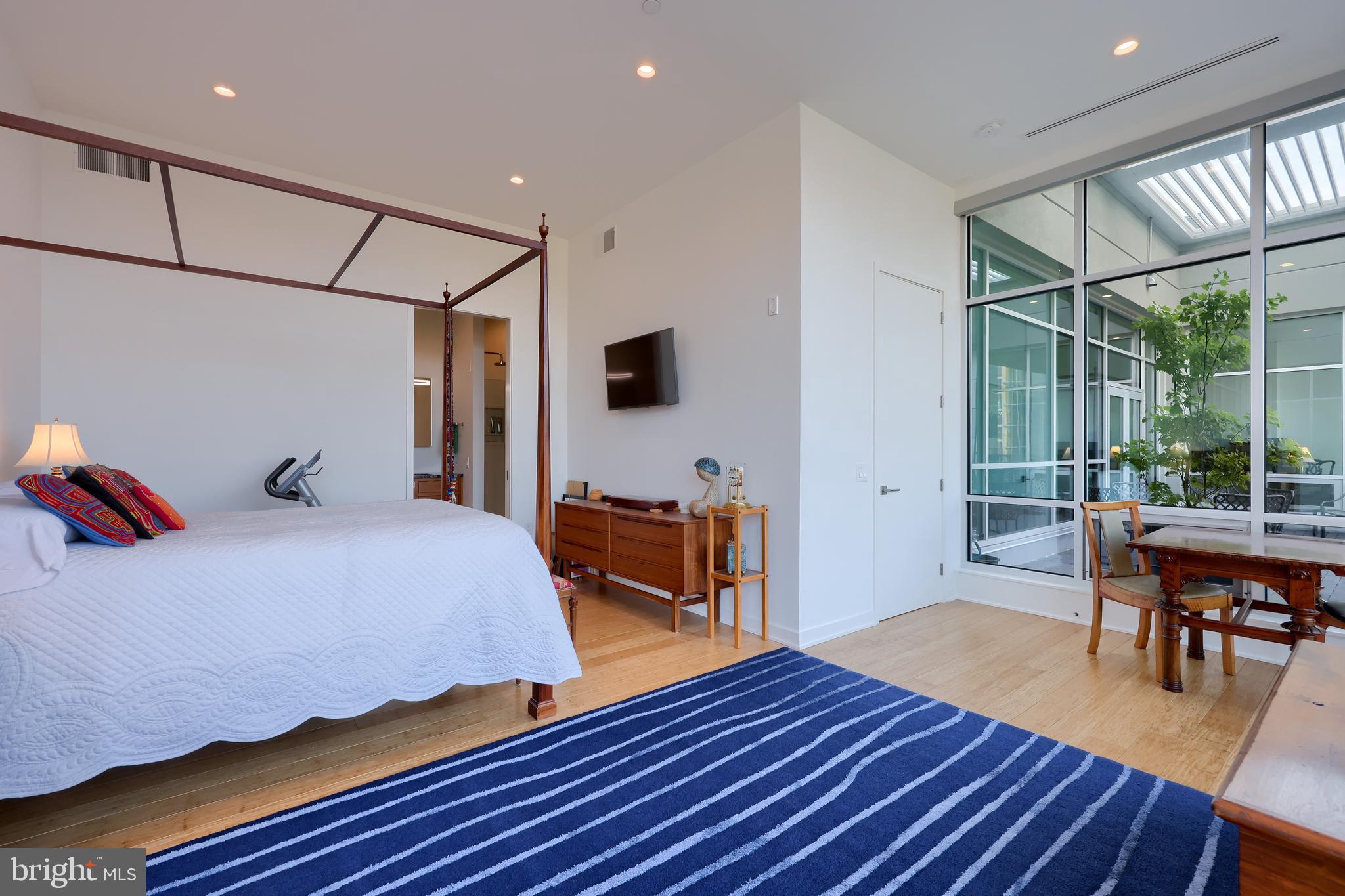 101 North Queen Street, Unit 404 Lancaster, PA 17603 - Photo 20 of 30 a bedroom with a bed and wooden floor