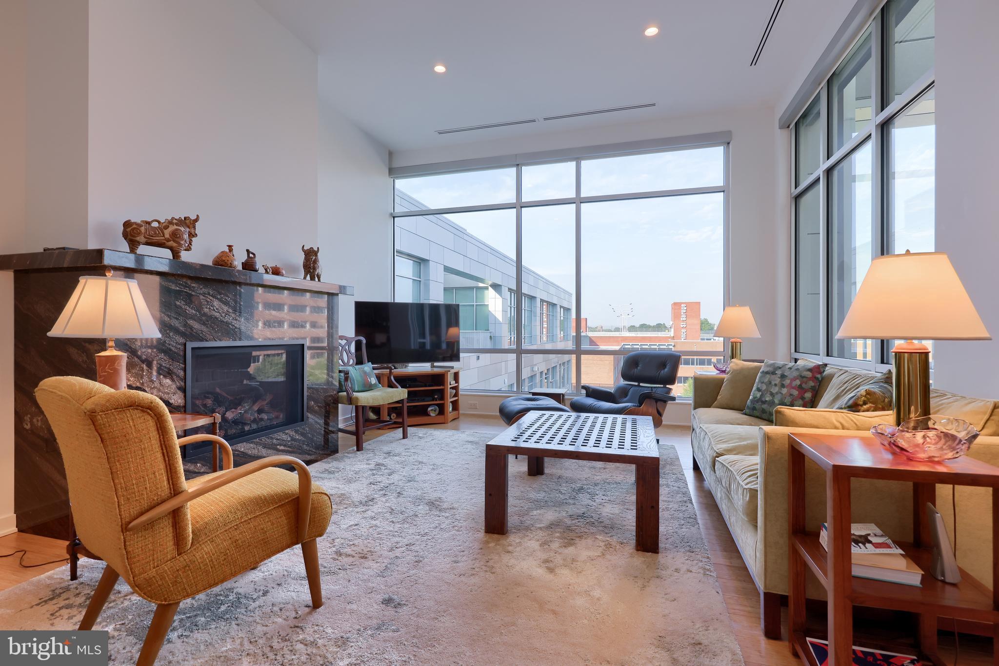 101 North Queen Street, Unit 404 Lancaster, PA 17603 - Photo 5 of 30 a living room with furniture a fireplace and a flat screen tv