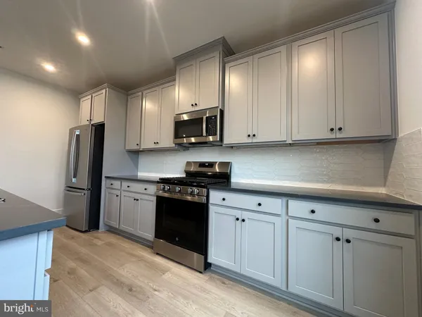 a kitchen with stainless steel appliances granite countertop a refrigerator sink and cabinets