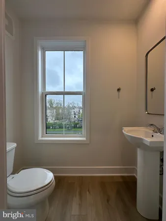 a bathroom with a toilet sink and window